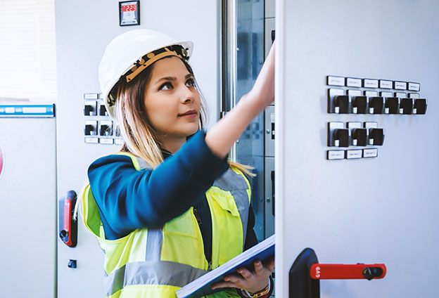 Young woman checking conducts in energy control room
